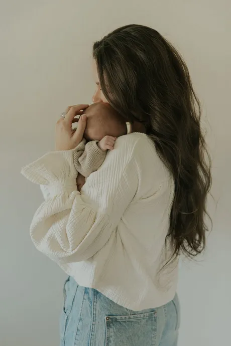 A mother holding her baby close